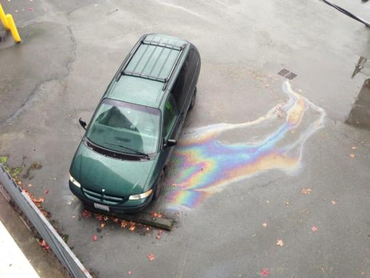 Van leaking oil into a stormwater inlet during a rainstorm